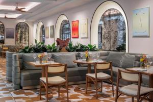 a restaurant with couches and tables and chairs at The Moore Miami in Miami