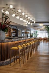 a row of stools at a bar in a restaurant at The Moore Miami in Miami