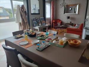 a table with food on it in a living room at Chambre art deco Gatsby dans maison d'hote "Le Petit Clouet" - Rochecorbon in Rochecorbon +16 photos