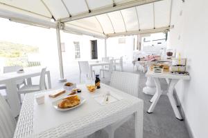 un tavolo bianco con un piatto di cibo sopra di Bed and Breakfast Arcobaleno a Peschici