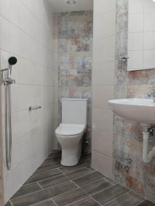 a bathroom with a toilet and a sink at Flora Beach House in Kremasti