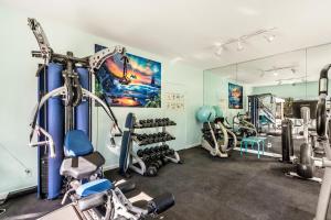a gym with treadmills and machines in a room at Fairway Terrace F-107 in Waikoloa Village