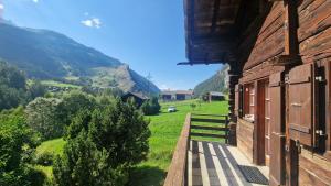 a balcony of a building with a view of a mountain at La Granzeta - Chalet- Authentique - Evolene in Evolène