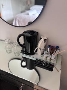 a shelf with a coffee maker and a mirror at Beechwood House Accommodation in Blarney