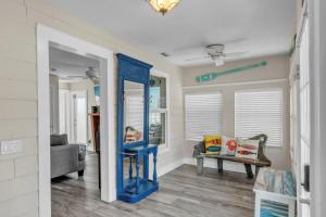 a living room with a blue mirror and a couch at Shady Mango home in Anna Maria +38 photos