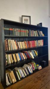 a book shelf filled with lots of books at Relaxing Days at Renaissance Castle - 2BR in Kalsdorf bei Ilz