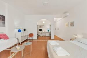 a white bedroom with two beds and a couch at Vernazza Prestige 5TERRE 30 mt the sea AC in Vernazza