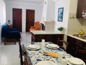 a kitchen with a table with plates on it at Refugio Terrace House Peniche in Atouguia da Baleia