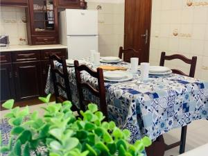 a dining room table with a blue and white table cloth at Refugio Terrace House Peniche in Atouguia da Baleia