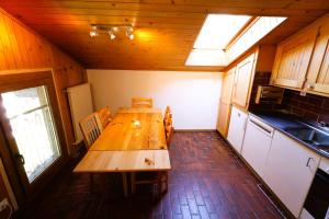 a kitchen with a wooden table in a room at Le Chamois 35 - Appartement 6 personnes Evolene in Evolène