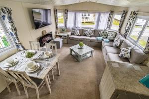 a living room with a couch and a table at 13 The Avenue in Tattershall
