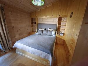 a bedroom with a bed in a wooden room at Villa Verde by Hvalstrand beach in Nesbru