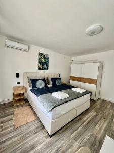 a bedroom with a large bed with blue pillows at Natura Lux Holiday House with Pool and Jacuzzi in Veliko Trojstvo +50 photos