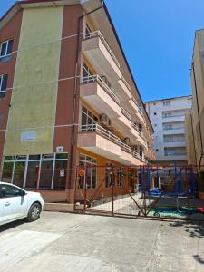 a building under construction with a car parked in front at Vila njoy by the sea in Eforie Sud