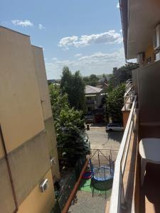 an apartment balcony with a view of a yard at Vila njoy by the sea in Eforie Sud