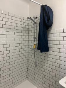 a shower with a black umbrella hanging on a wall at Dumas St-Germain de calberte in Saint-Germain-de-Calberte +8 photos