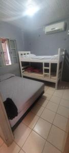 a bedroom with two bunk beds and a fan at Toca dos Gatos in Santarém
