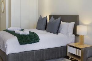 a bedroom with a bed with towels on it at Ellipse Waterfall 3802 in Midrand +11 photos