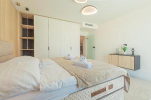 a bedroom with a bed with two towels on it at Seafront Villa Serena with pool and seaview in Privlaka +30 photos