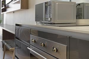 a kitchen with a counter with a microwave on it at Ellipse Waterfall 3802 in Midrand