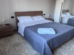 a bedroom with a large bed with a blue blanket at Casa Vacanza Cupello in Cupello +11 photos