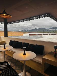 a room with a couch and tables and a view at 17Stories 2 in Pai