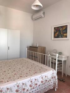 a bedroom with a bed and a table and a desk at Villa del Tramonto in Santa Caterina +4 photos