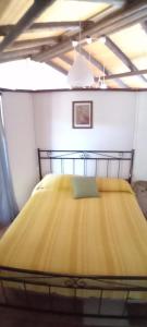duże żółte łóżko w pokoju z sufitem w obiekcie Alle Riserve Vendicari w mieście Casa Maccari