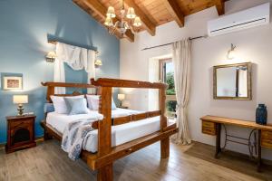a bedroom with a wooden bed and a mirror at Spacious Stone Villa with Private Pool, Sea View & Sunset Views in Astérion +59 photos