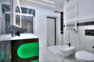 a bathroom with a green sink and a toilet at Sea View 1B Apartment, Théoule in Théoule-sur-Mer +6 photos