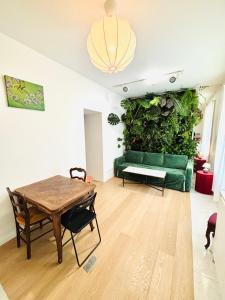 ein Wohnzimmer mit einer grünen Pflanzenwand in der Unterkunft Appartement Malesherbes Wagram in Paris