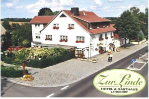 a large white house on the side of a road at Familienhotel Zur Linde in Panschwitz-Kuckau