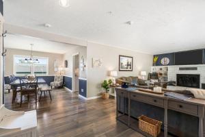 a living room and dining room with a kitchen and dining table at Branson Downtown Beauty - 4 BDR Home Sleeps 15 in Branson