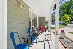 a porch with chairs and tables on a house at Branson Downtown Beauty - 4 BDR Home Sleeps 15 in Branson