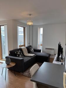 a living room with a couch and a table at LUX 2bed City Centre and AO Arena Free Parking Modern Apt in Manchester