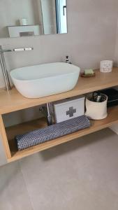 a bathroom counter with a sink and a mirror at Cottage Playa Cabeiro in Porto do Son +35 photos