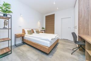 a bedroom with a bed and a desk at Deluxe Apartment on Granary Island with Parking - Granaria I & by Noclegi Renters in Gdańsk