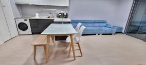 a kitchen with a table and chairs in a living room at Yeosu U-Bless Terrace Ocean View in Yeosu