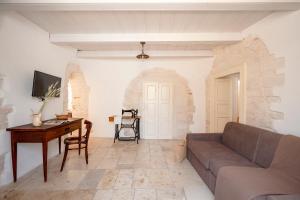 a living room with a couch and a table at Trulli Lithos Suite in Alberobello