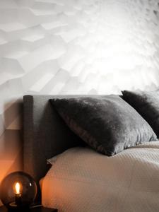 a bed with a pillow and a lamp on a table at Ferienwohnung Agora Penthouse am Goitzschesee 