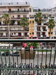 a balcony with a flower pot on a city street at A I R Sorrento House in Sorrento