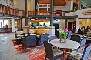 a lobby with a table and chairs and a kitchen at Wyndham Ka Eo Kai 2BR Villa with Resort Access in Princeville +36 photos