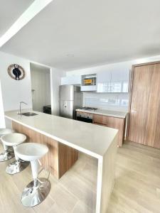 a kitchen with a large white counter in a kitchen at Hermoso apartamento serena del mar #1 in Puerto Tierrabaja