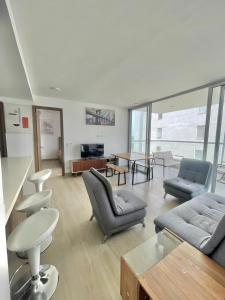 a living room with couches and chairs and a table at Hermoso apartamento serena del mar #1 in Puerto Tierrabaja