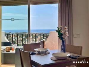 a dining room table with a view of the ocean at VH Costa Blanca - APARTAMENTO ABANTOS in Casas de Torrat