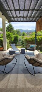 a patio with chairs and a table with a view at Cottage Playa Cabeiro in Porto do Son