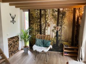 a living room with a wall mural of a forest at Romantik Wood in Waulsort