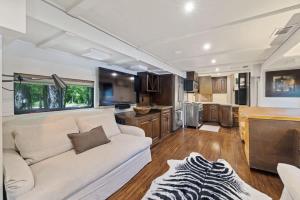 a living room with a white couch and a kitchen at 7744 Ranch Entire Resort in Austin +83 photos