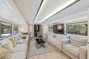 a living room with white furniture and windows at Studio 7744 Ranch Austin Venue and Rentals in Austin