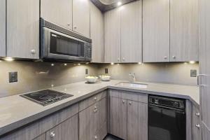 a kitchen with a microwave and a stove top oven at Studio 7744 Ranch Austin Venue and Rentals in Austin